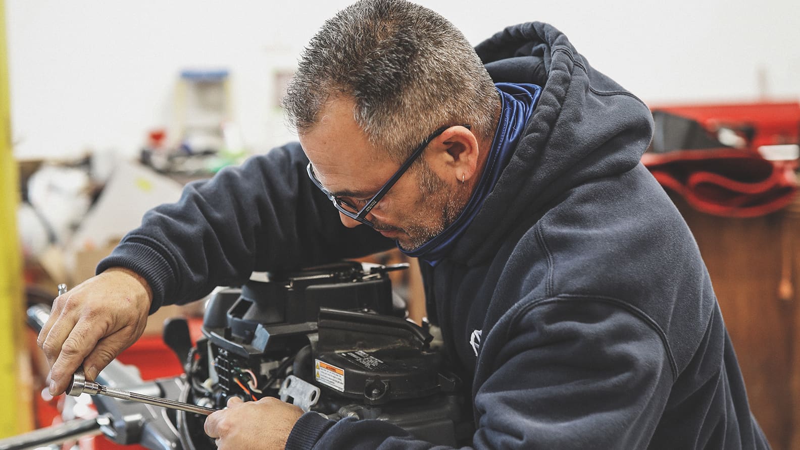man fixing engine