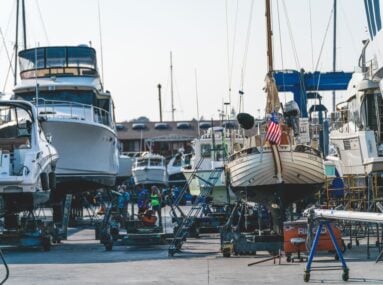 boats of various sizes lifted up on platforms out of the water