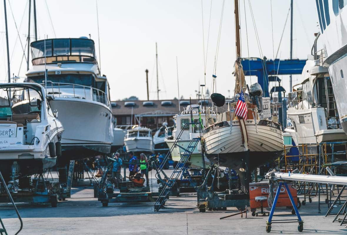 boats of various sizes lifted up on platforms out of the water