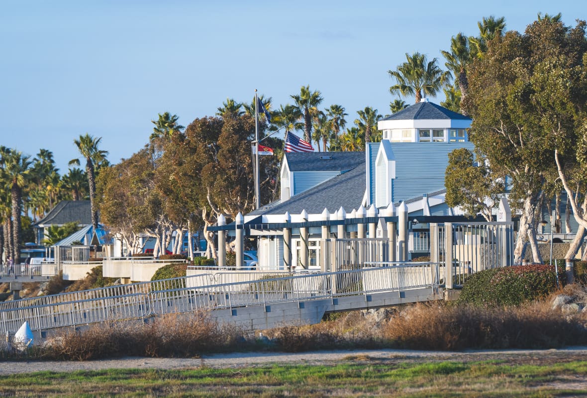 blue and white buildings with flags and a ramp
