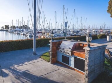 an outdoor barbecue next to a marina