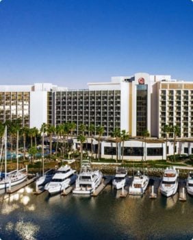 yachts docked in front of large Sheraton hotel