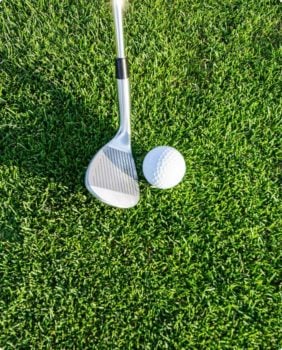 close up of golf club and golf ball