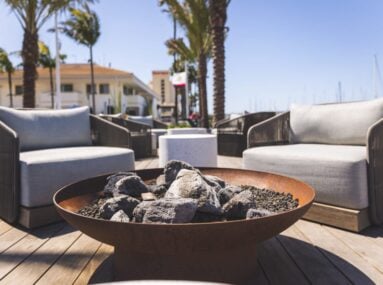 close up of firepit on deck with two chairs