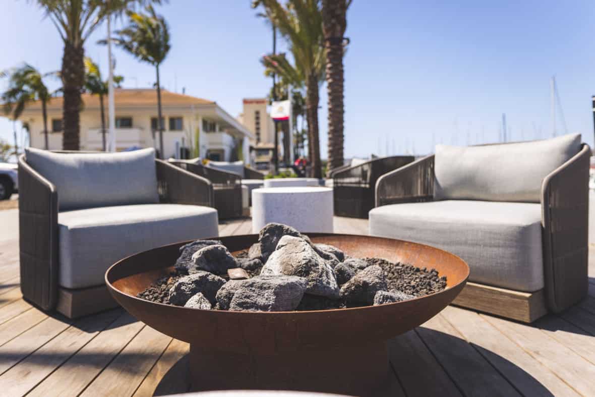 close up of firepit on deck with two chairs